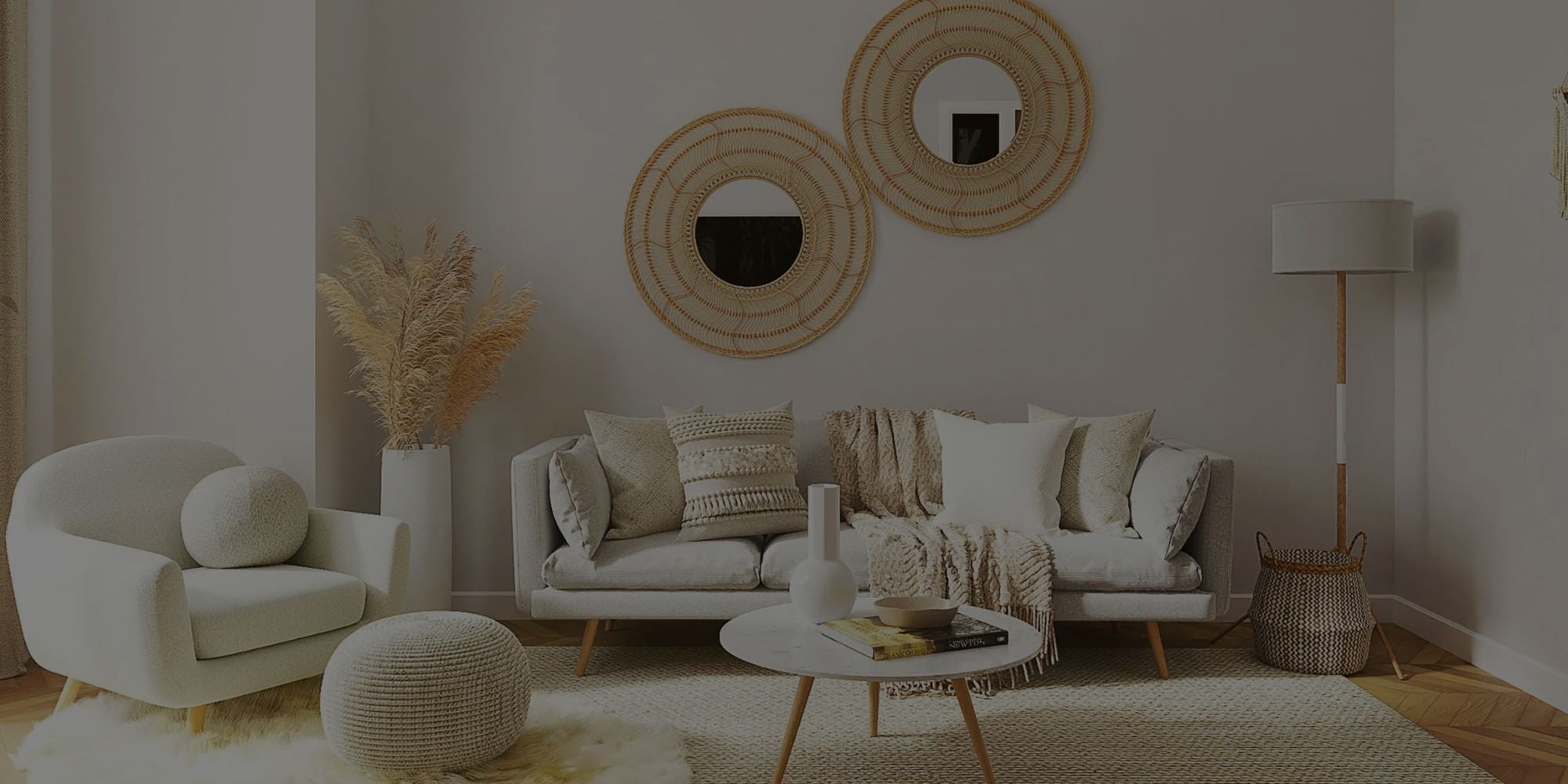 Modern living room with white sofa, armchair, and decorative elements.