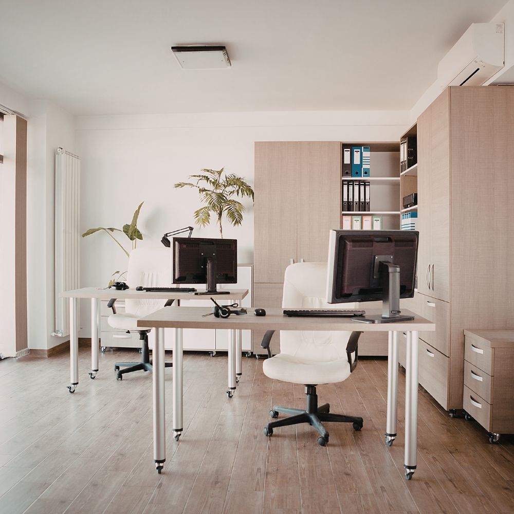 Modern office space with desks, chairs, and office equipment.