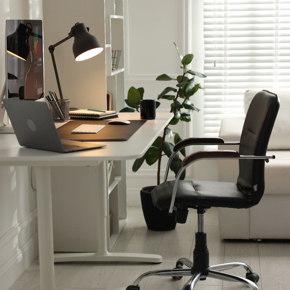 Modern home office with a desk, chair, and computer setup.